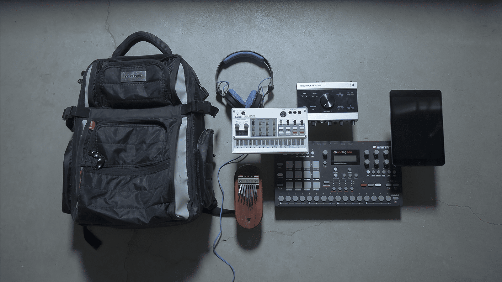 Travel essentials for musicians including backpacks, laptops, audio interfaces, and power supplies