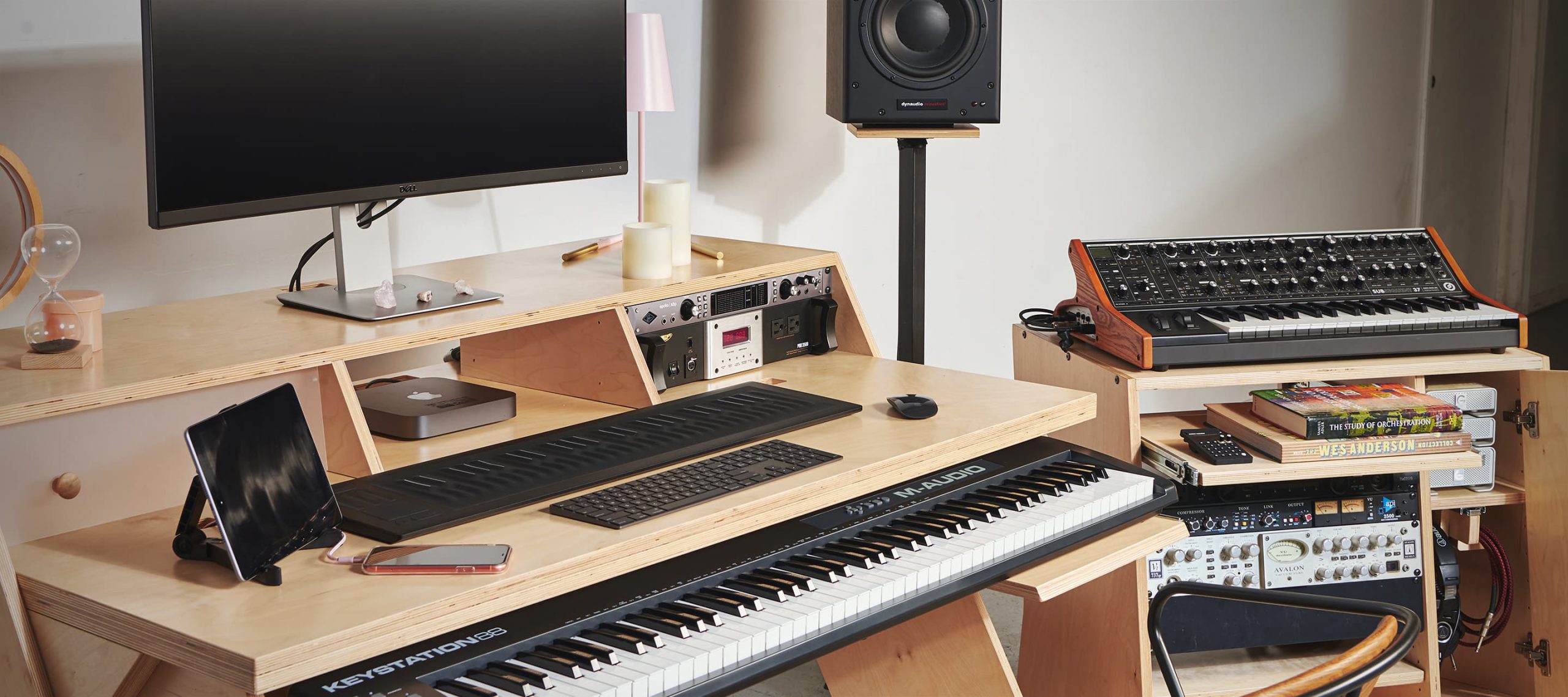 Output natural color Platform desk with Output natural color Sidecar accessory holding preamps, MIDI keyboard, and display monitor.