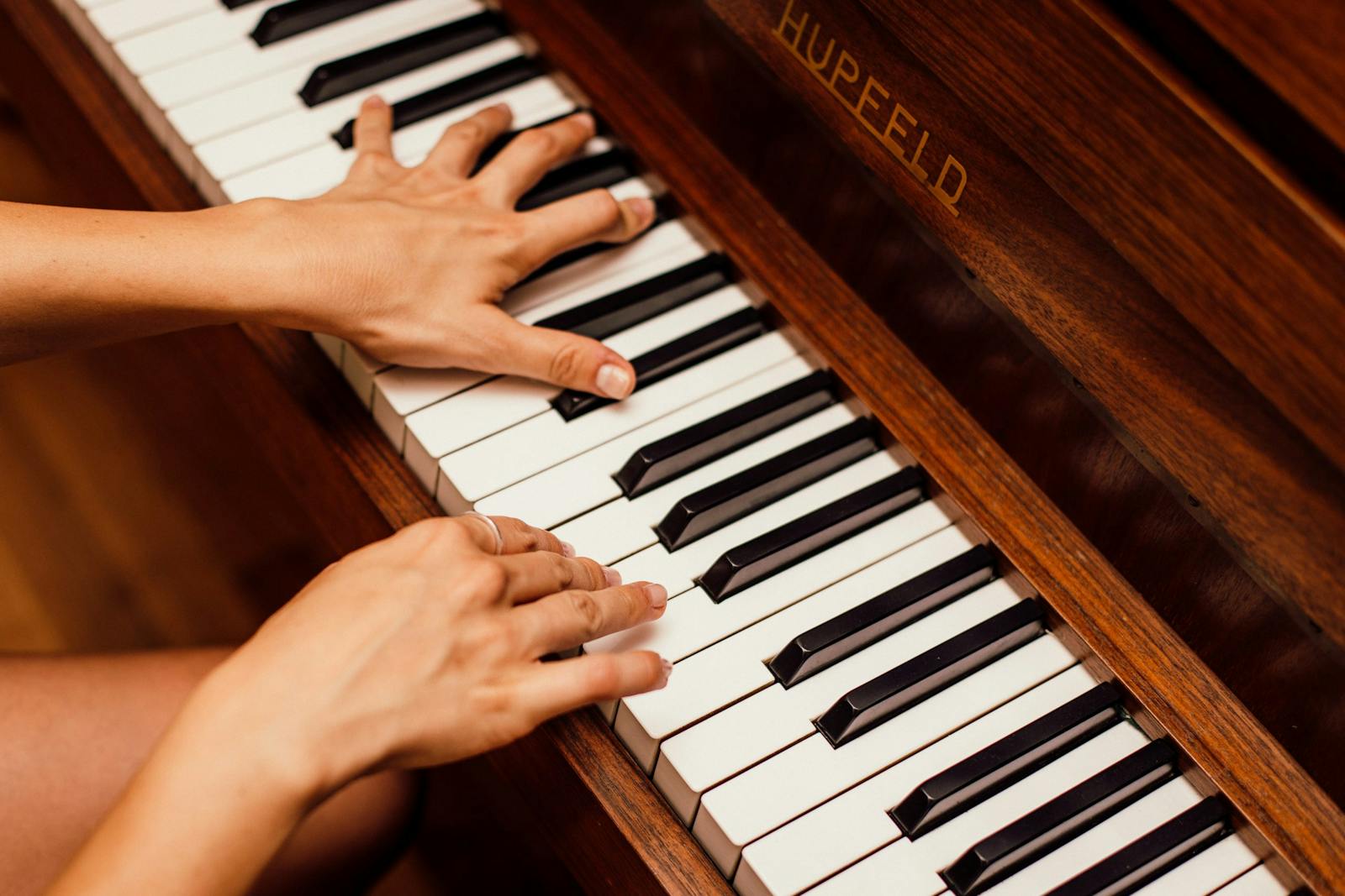 Musician practicing on a Hupfeld piano